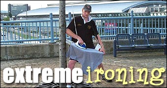 Martin Bacon practices extreme ironing on the bridge over Park Square roundabout, Sheffield