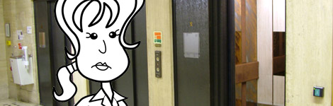 Alice waiting at the lift in the hospital 