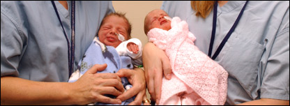 Nurses holding new born babies