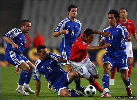 Theo Walcott is surrounded by Andorran defenders