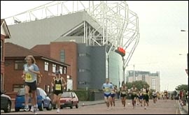 Runers going past Old Trafford