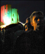 The crowd silhouetted against the castle