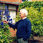 John at home in his garden tending to his Delphimiums