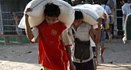 Workers unload rice sacks in Burma 