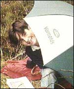 John Paul under an umbrella