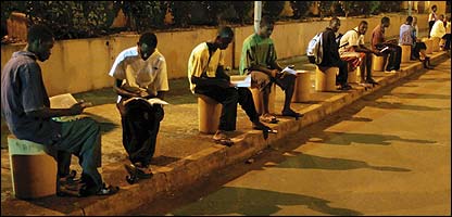Students study in G'bessi airport carpark in Conakry