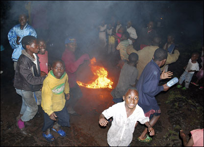 Children dance around a burning tyre in Goma during festivities