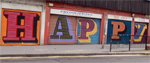 the word 'happy' written on the outside of some buildings