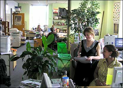Claire and Deiniol admiring one of the office plants
