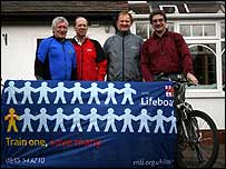  Group of people standing holding a banner