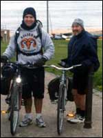 Two men standing near their cycles