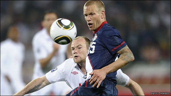 Jay DeMerit tangles with Wayne Rooney during a World Cup match in South Africa