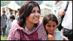 Baroness Warsi with a young flood survivor in Pir Sabak, Pakistan. Credit: Vicki Francis / Kate Joseph / Department for International Development (DFID)