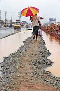 A shopper keeps to higher ground as the heavens open. From Immanuel Afolabi, Lagos