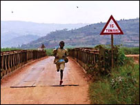 Film still of young boy running across a bridge