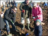 Family planting trees