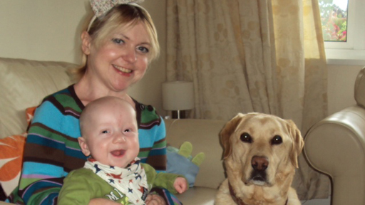 Caroline with baby Christopher and assistant dog Yasmin