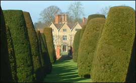 Packwood House seen through yew trees 