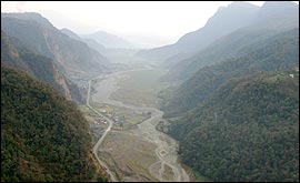 The Pokhara road runs through the valley below
