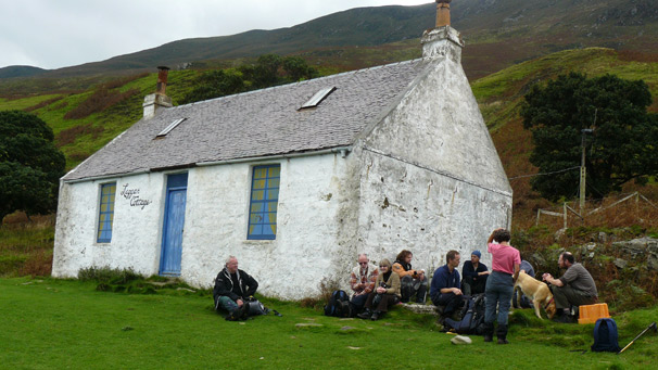 Walkers and kayakers having lunch beside Laggan bothy