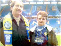 Two people on the pitch at Elland Road.