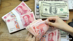 Chinese yen being counted out beside US dollars