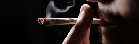 A man smoking a cannabis joint