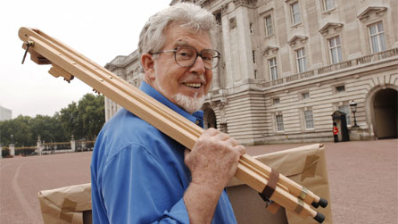 Rolf Harris outside Buckingham Palace while filming The Queen By Rolf