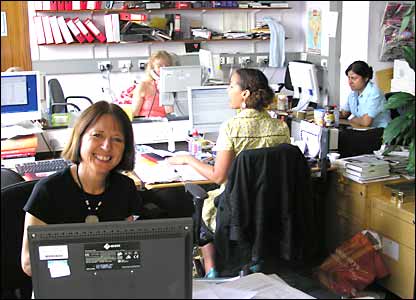 Outlook presenter Heather Payton sitting at her desk
