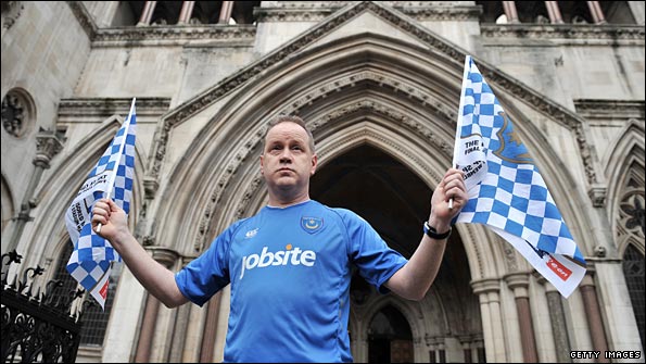 A loyal Portsmouth fan outside the High Court