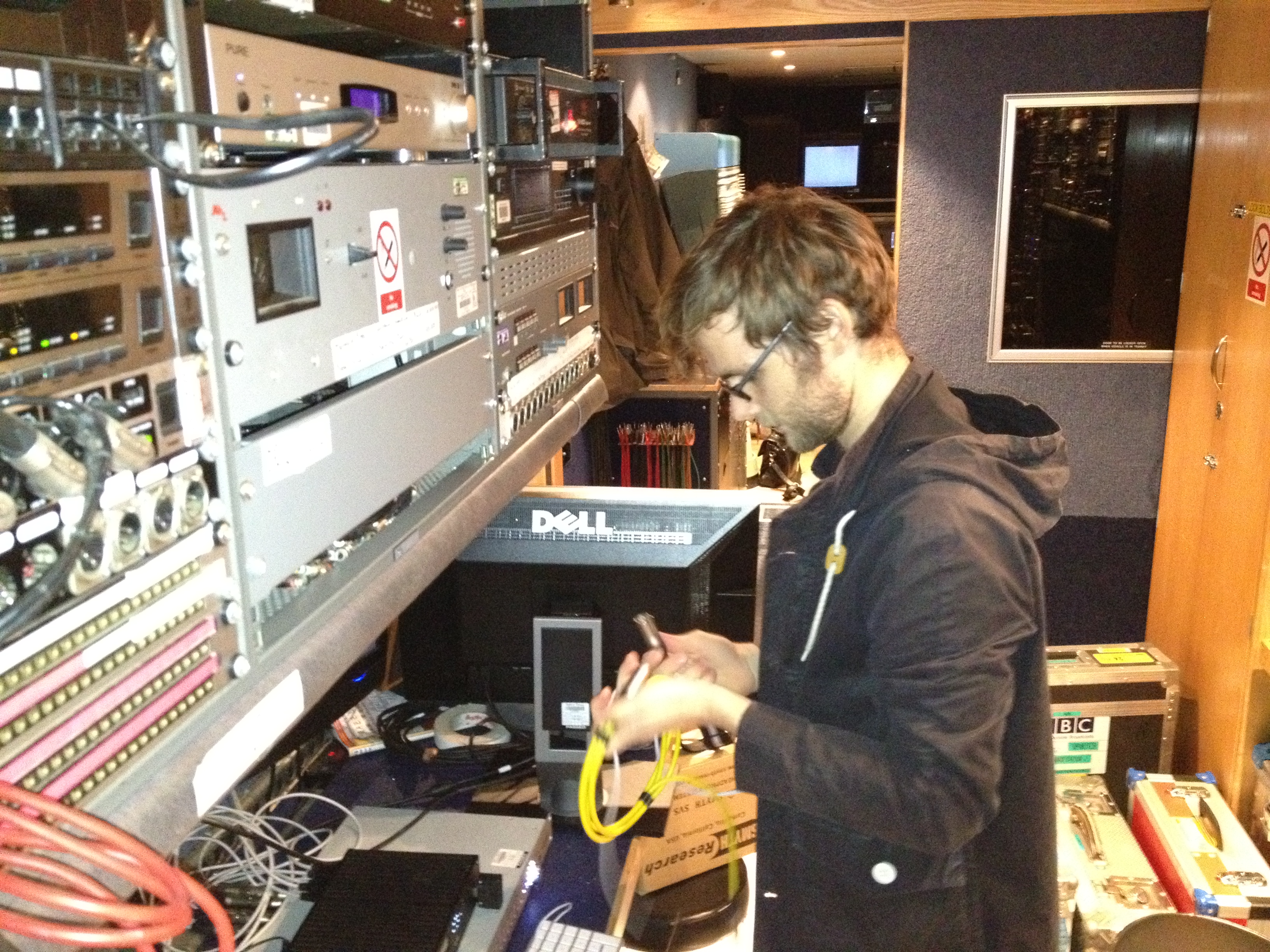 Chris Pike setting up the recording equipment in the back of the outside broadcast truck