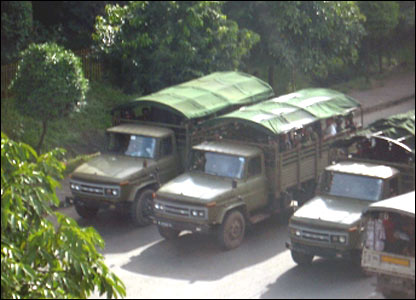 Military trucks in the street.