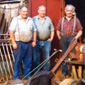 Leith on the left, outside his workshop in Doagh with the local coalman and motor mechanic