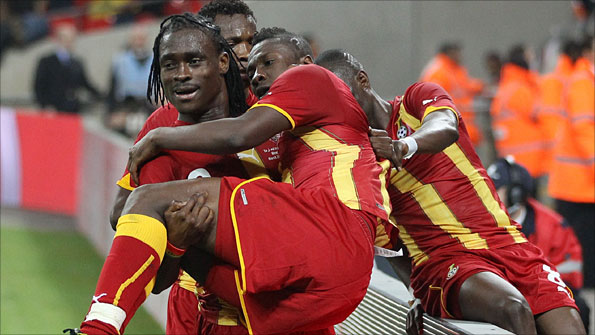 Ghana's Derek Boateng carries goalscorer Asamoah Gyan