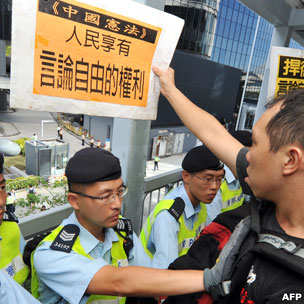 香港新政府总部外警员挡着一名示威者(18/8/2011)