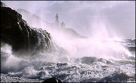 Stormy seas smashing up against cliffs - Photo by Brian Morgan