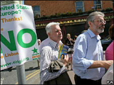 Sinn Fein's Sean Crowe (L) and Gerry Adams canvas for a