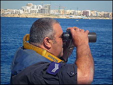 Coastguard scanning with binoculars