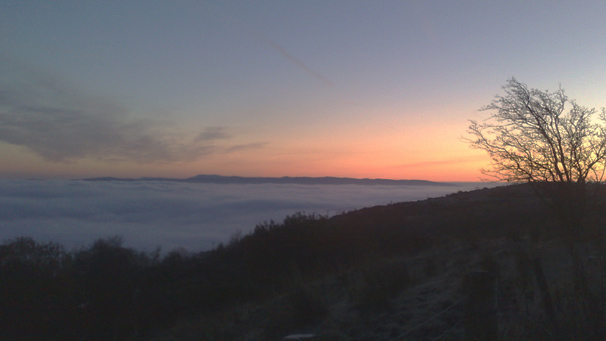 Looking down on a layer of cloud, as dawn breaks