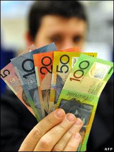 A shopper brandishes Australian dollar banknotes in Sydney