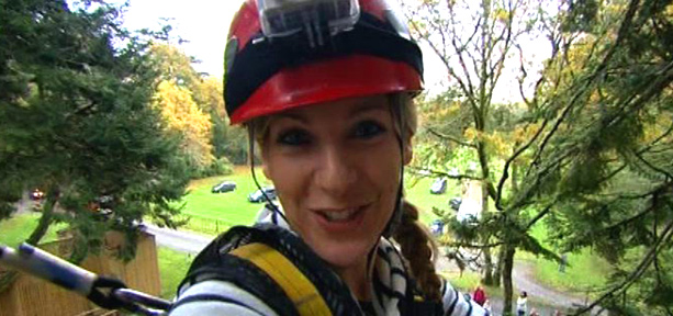 Naomi Wilkinson smiling whilst doing a highwire course
