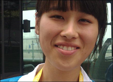 Volunteer Liu Fei from Shandong province is helping on the media shuttle buses
