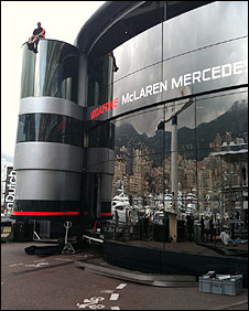 A McLaren team member takes a break from building their extravagant motorhome in the Monaco paddock