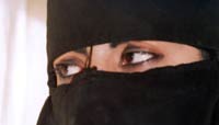 Woman in a face-concealing head veil with only her eyes visible