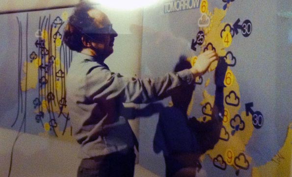 Michael Fish putting symbols on maps.