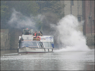 Archbishop approaching on a boat