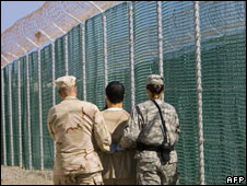 Prisoner and guards at Guantanamo Bay