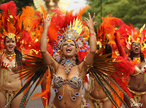 Performers dance in the streets of London at the Notting Hill Carnival. 