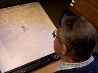 A genealogist using a microfiche reader