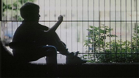 Plentyn yn eistedd ar wal